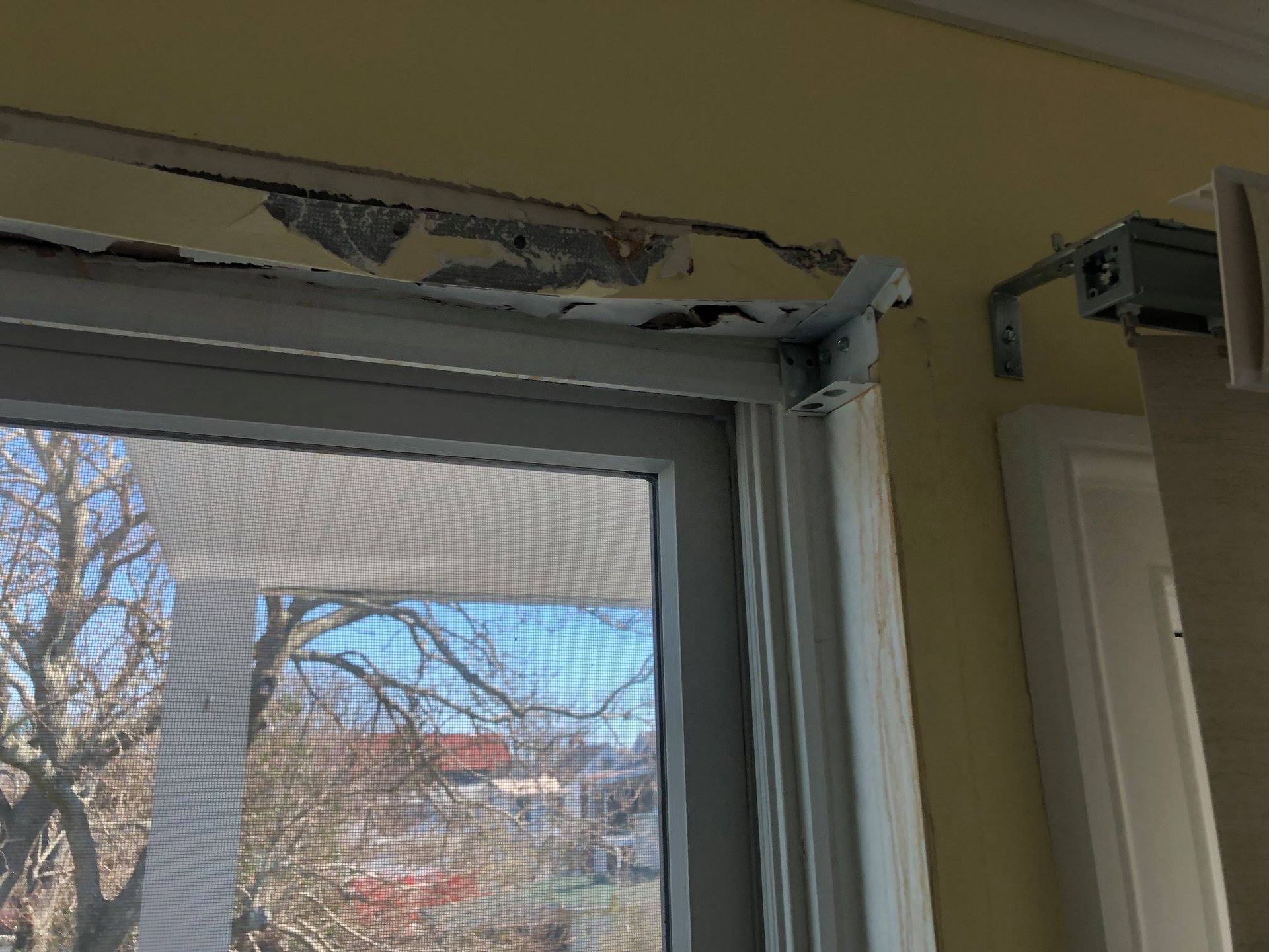 A close up of a window with a screen on it in a room.