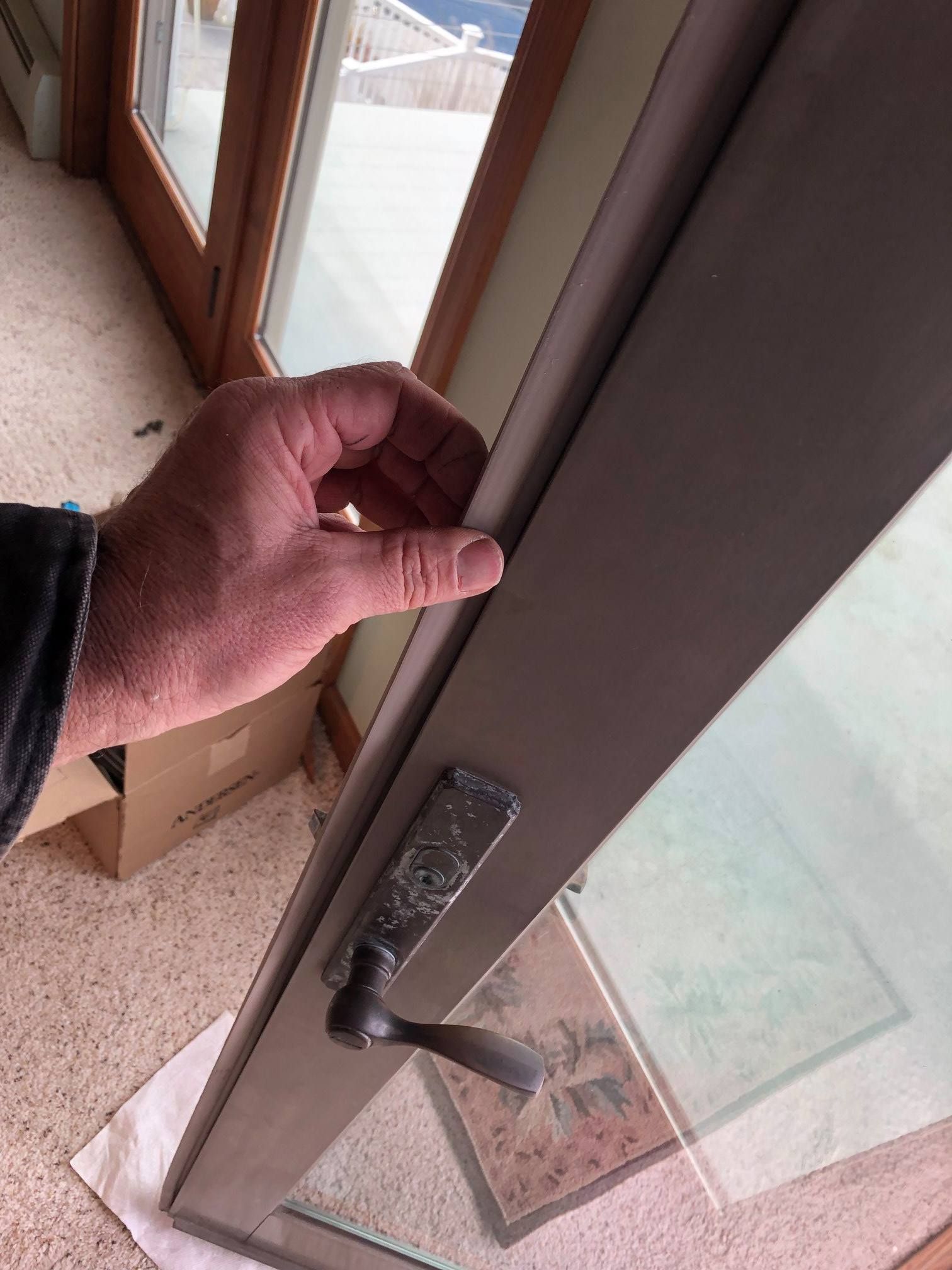 A person is opening a door with their hand