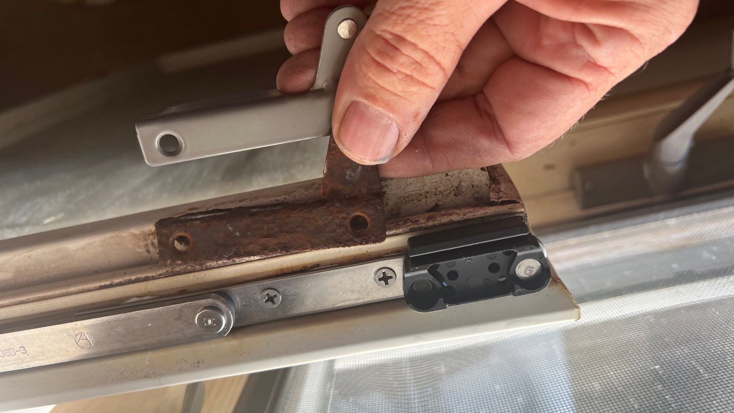 A person is holding a piece of metal in their hand.