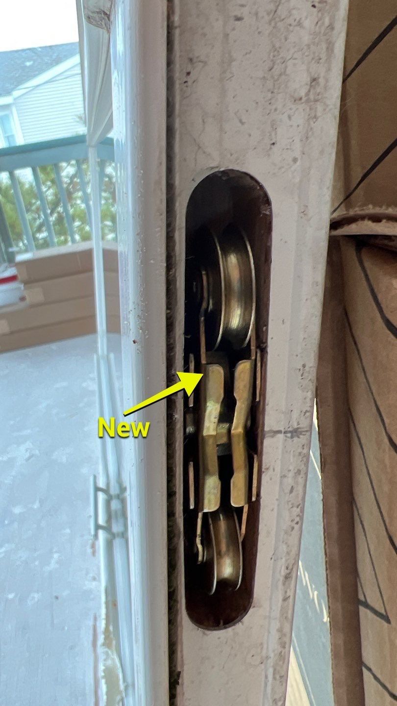 A close up of a door with a yellow arrow pointing to a new lock.
