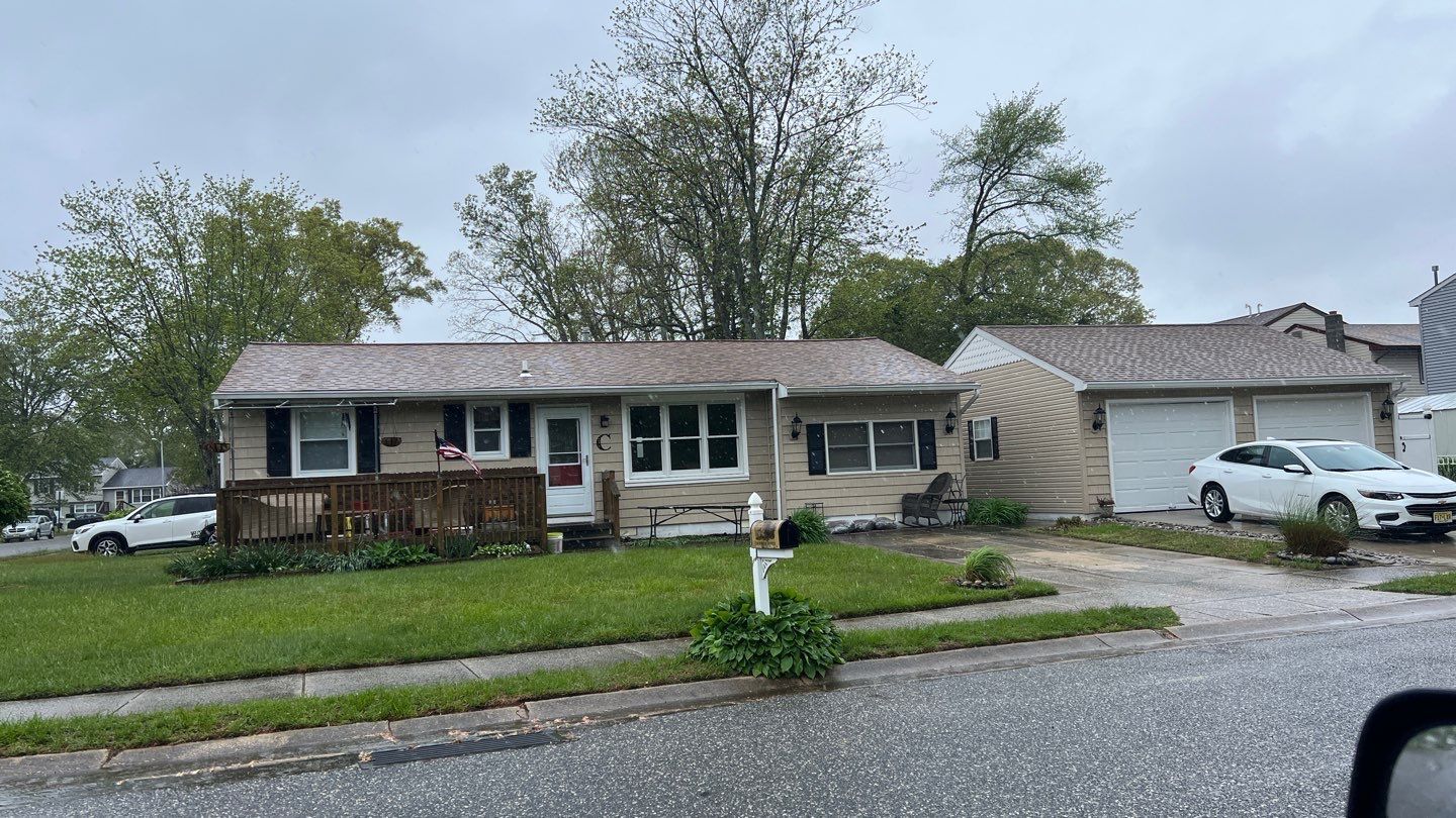 A house with a car parked in front of it.