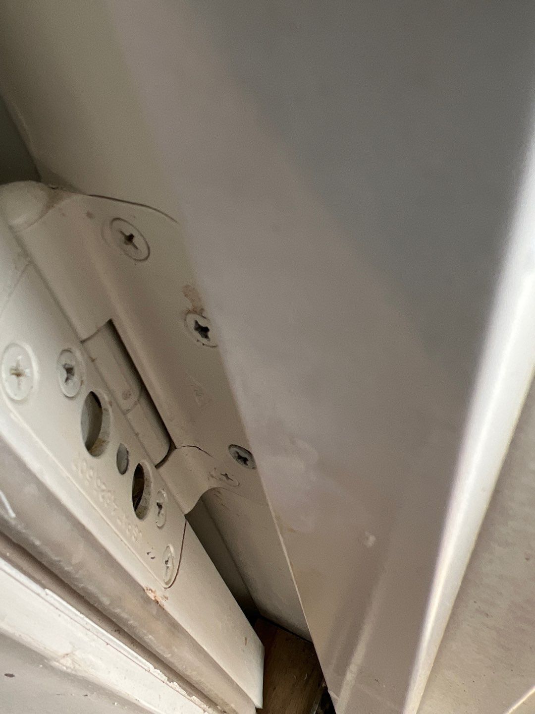 A close up of a white wall with a few holes in it.