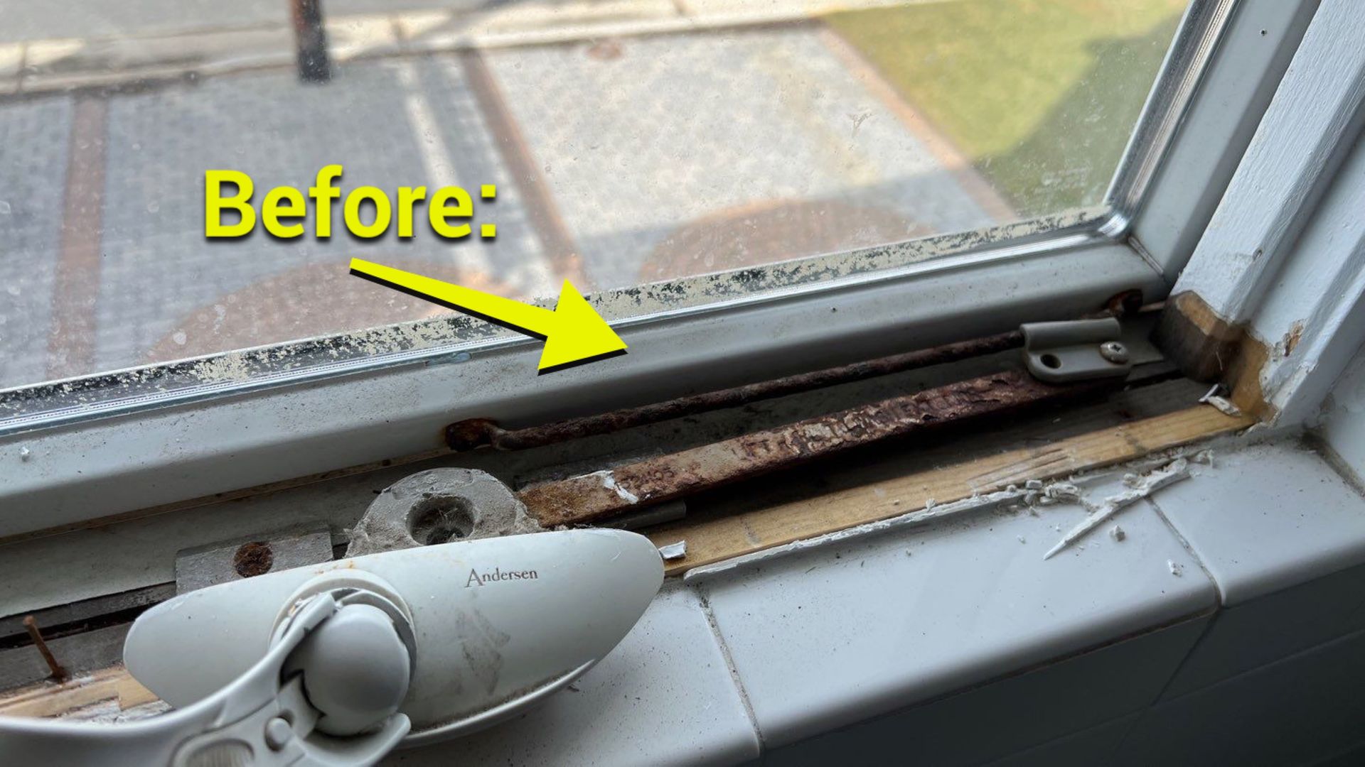 A before picture of a window with a yellow arrow pointing to it.