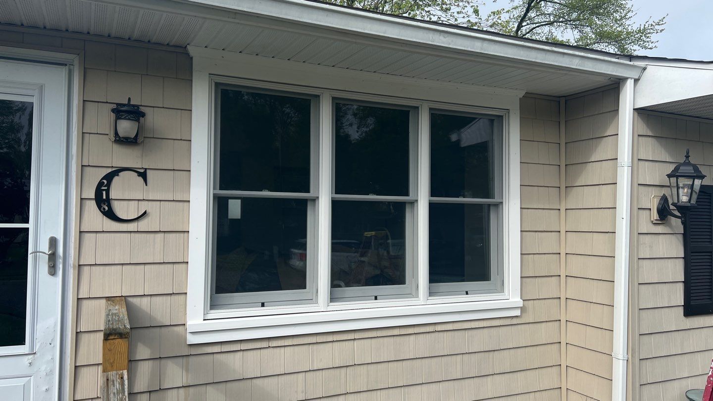 A house with a large window and a white door.