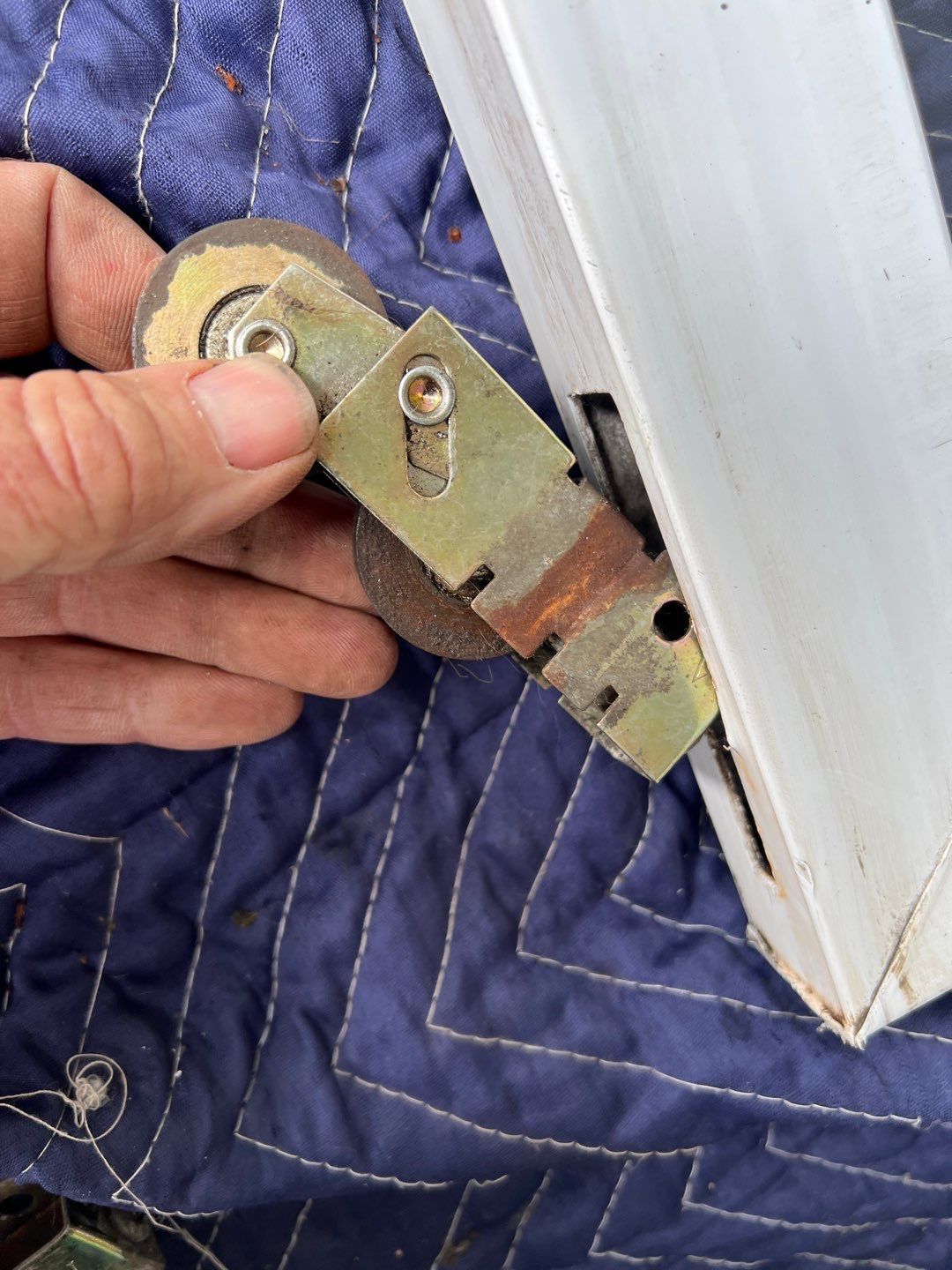 A person is holding a piece of metal in their hand.