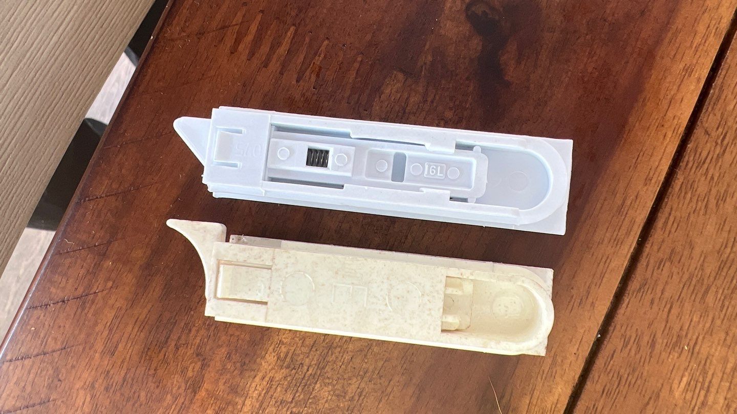 Two white objects are sitting on a wooden table.