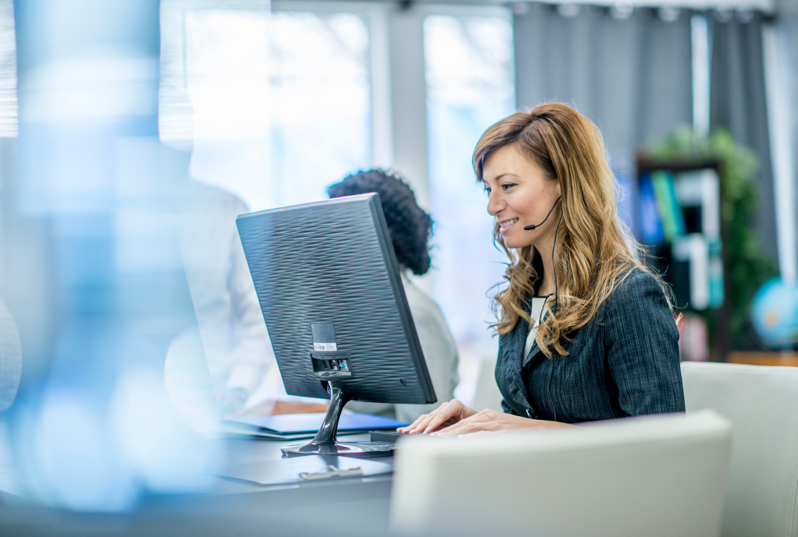 A bunch of blue wires are connected to a server in a data center.