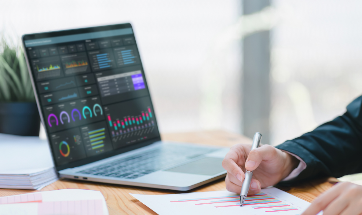 A clock , calculator , light bulb , and bills are on a table.