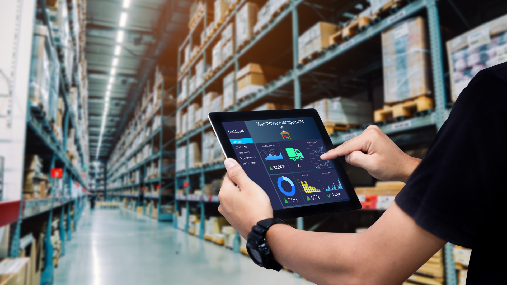 A man is using a tablet in a warehouse.