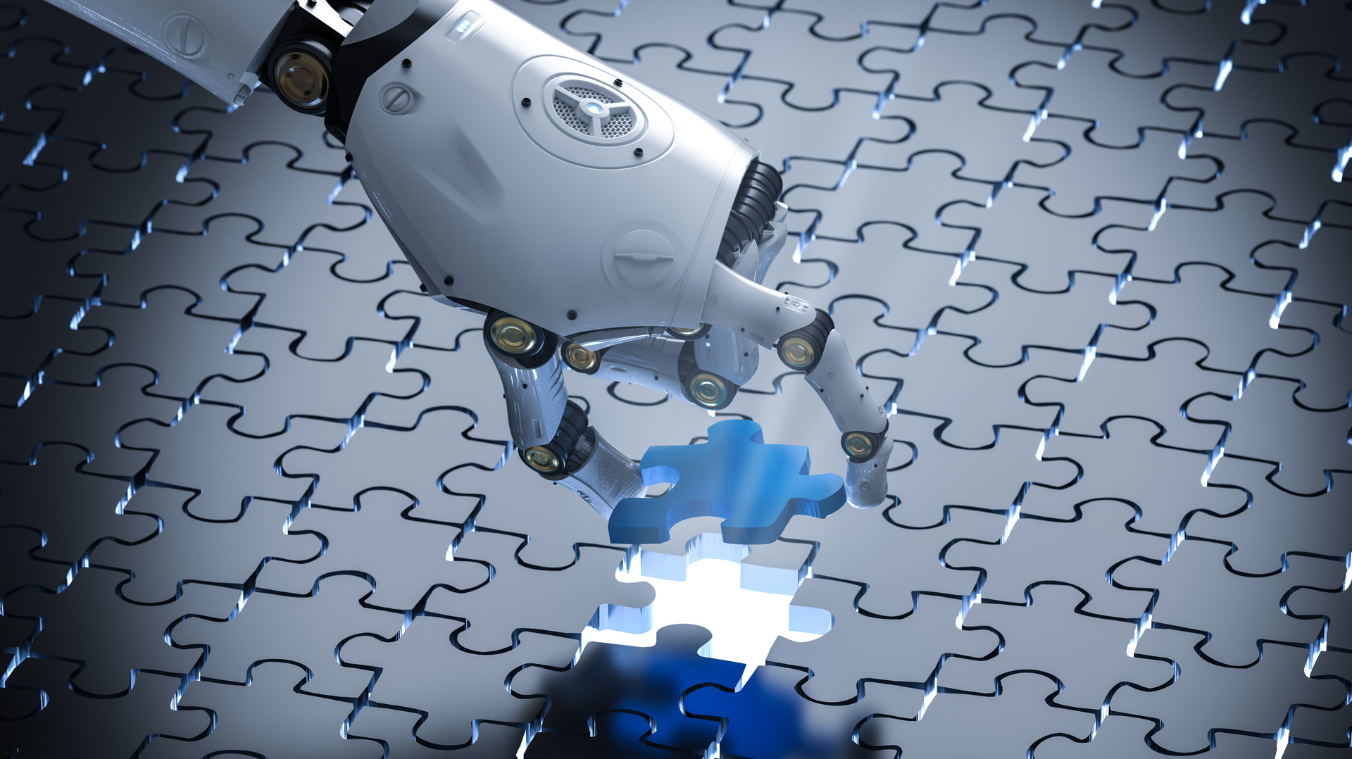 a robot 's hand is reaching for a piece of a puzzle .