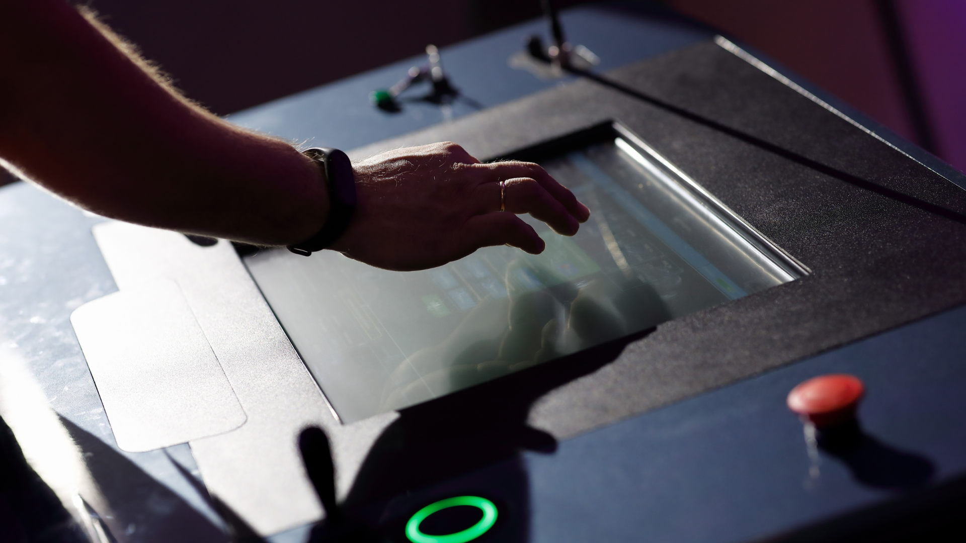 A person is pressing a button on a machine.