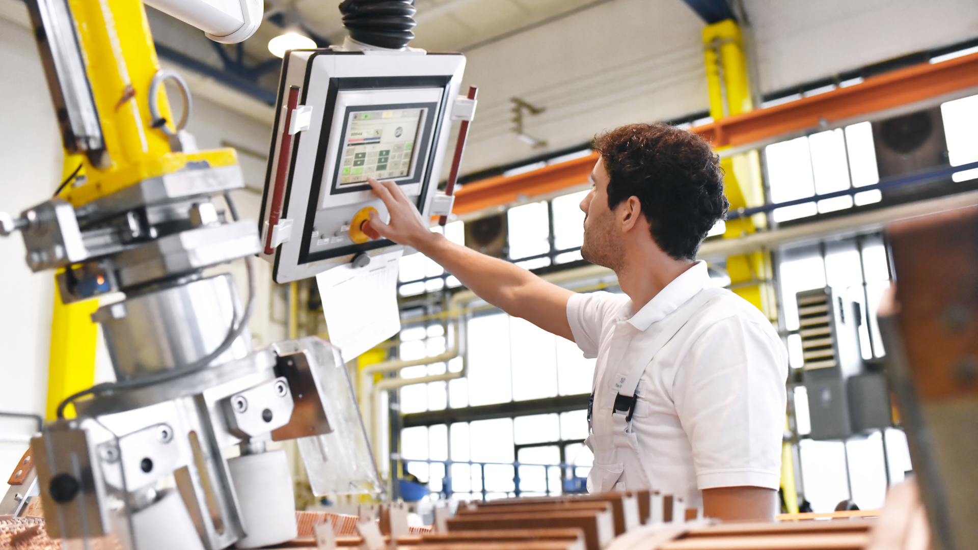 A man is working on a machine in a factory.