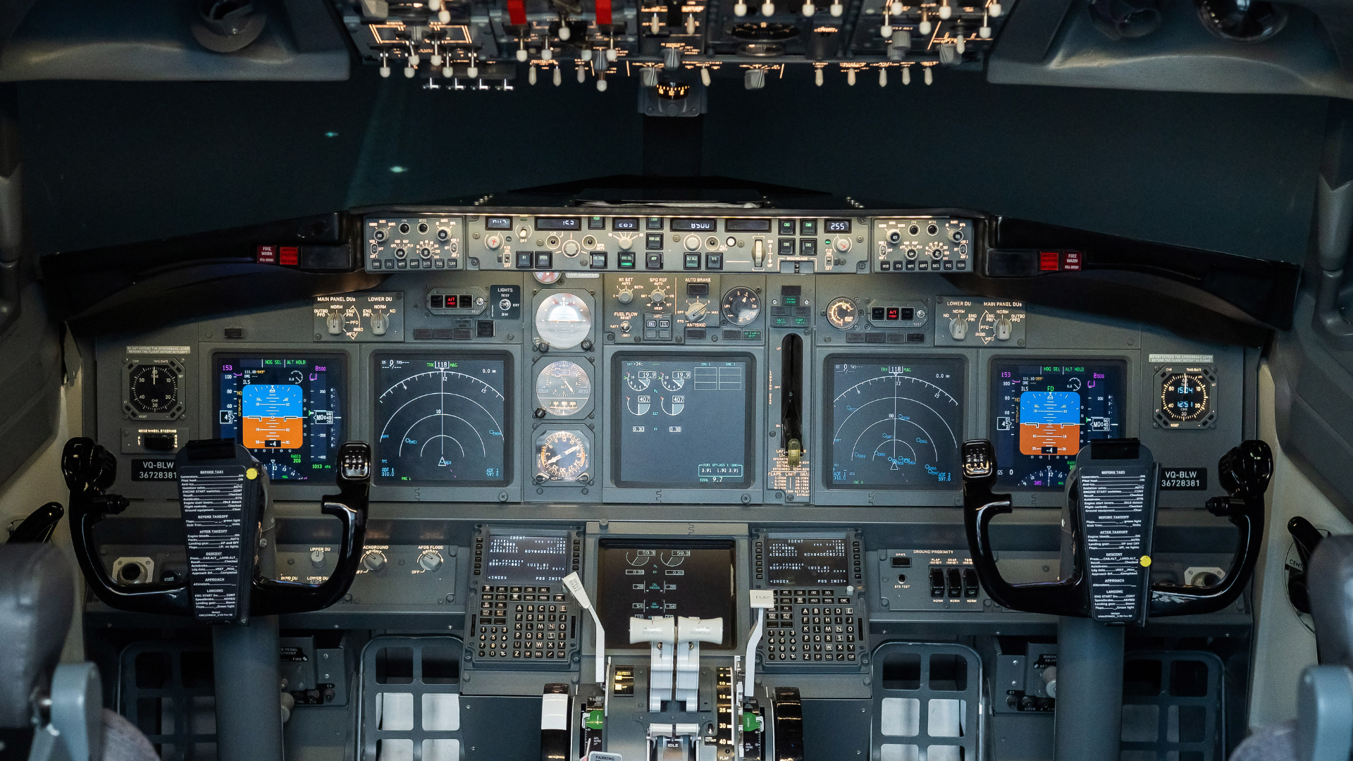 A cockpit of an airplane with a lot of controls