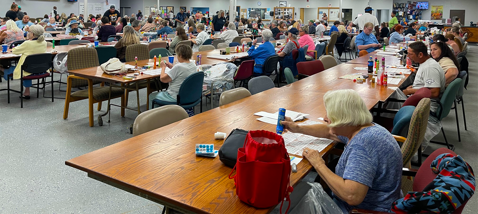 People playing bingo at large tables.