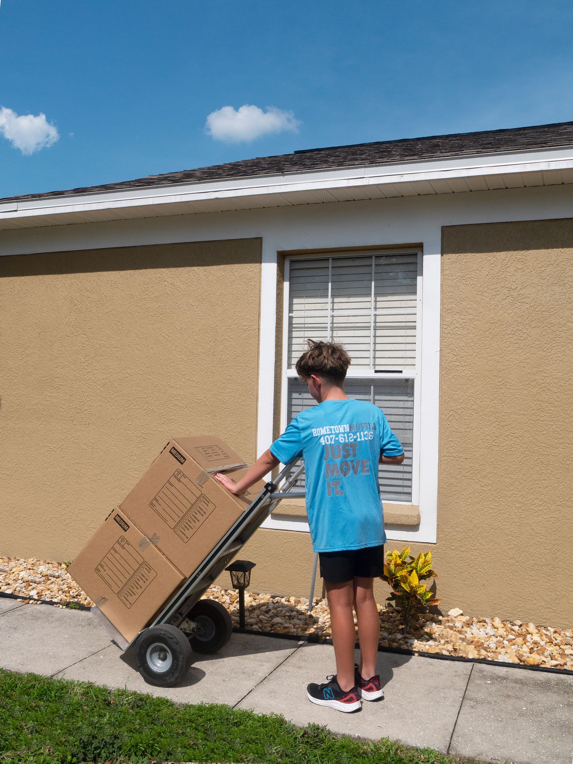 A man is carrying a mattress on his back.