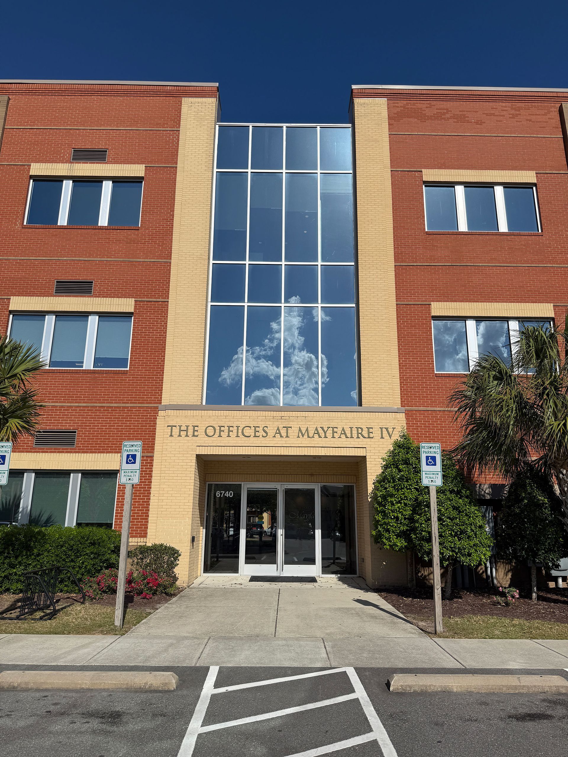A large brick building with a handicapped parking spot in front of it