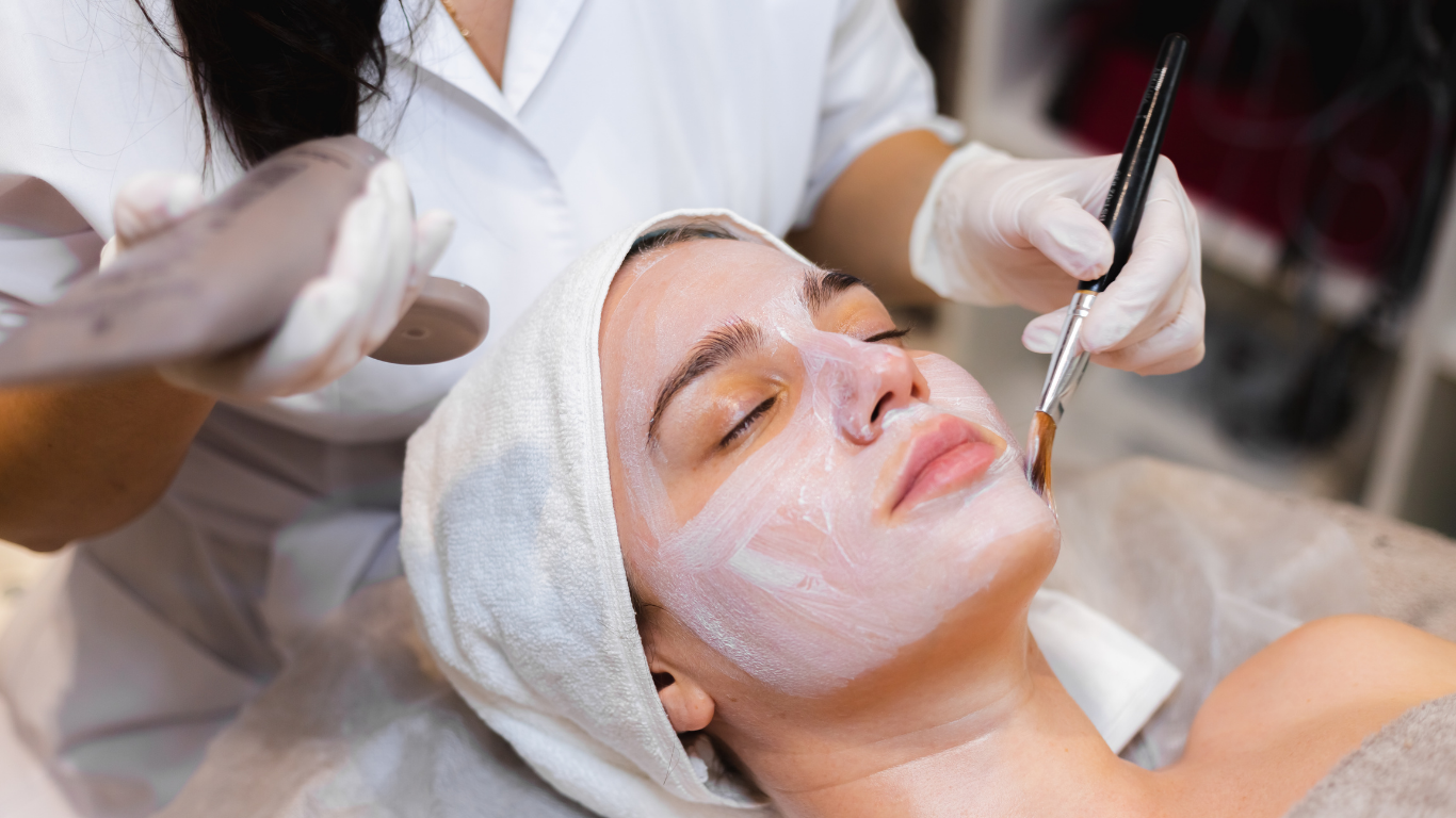 A woman is getting a facial treatment at a spa.