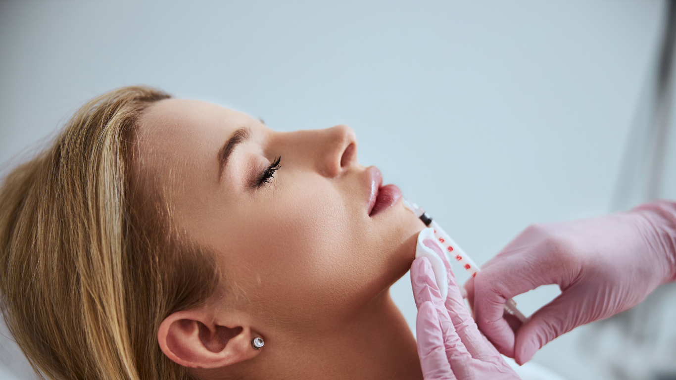 A woman is getting a botox injection in her face.