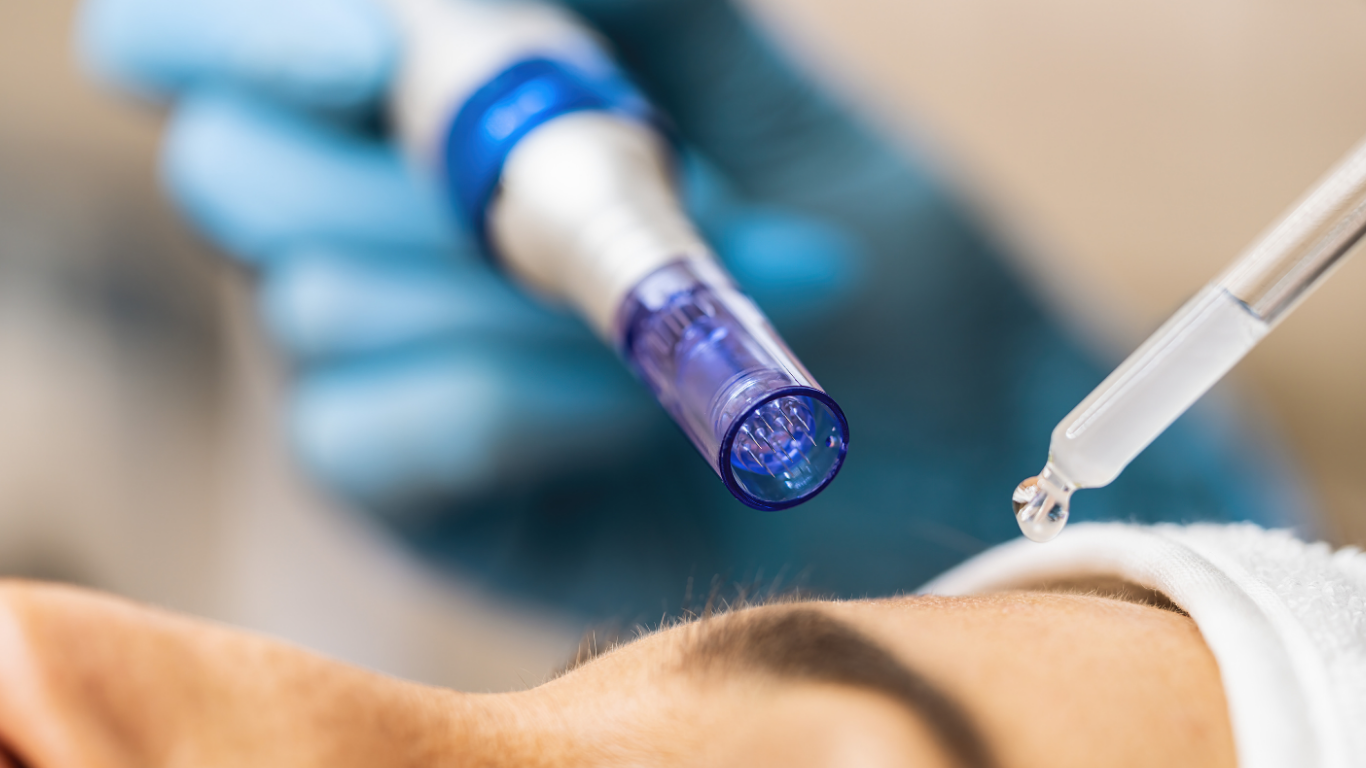 A person is getting a facial treatment with a machine and a dropper.