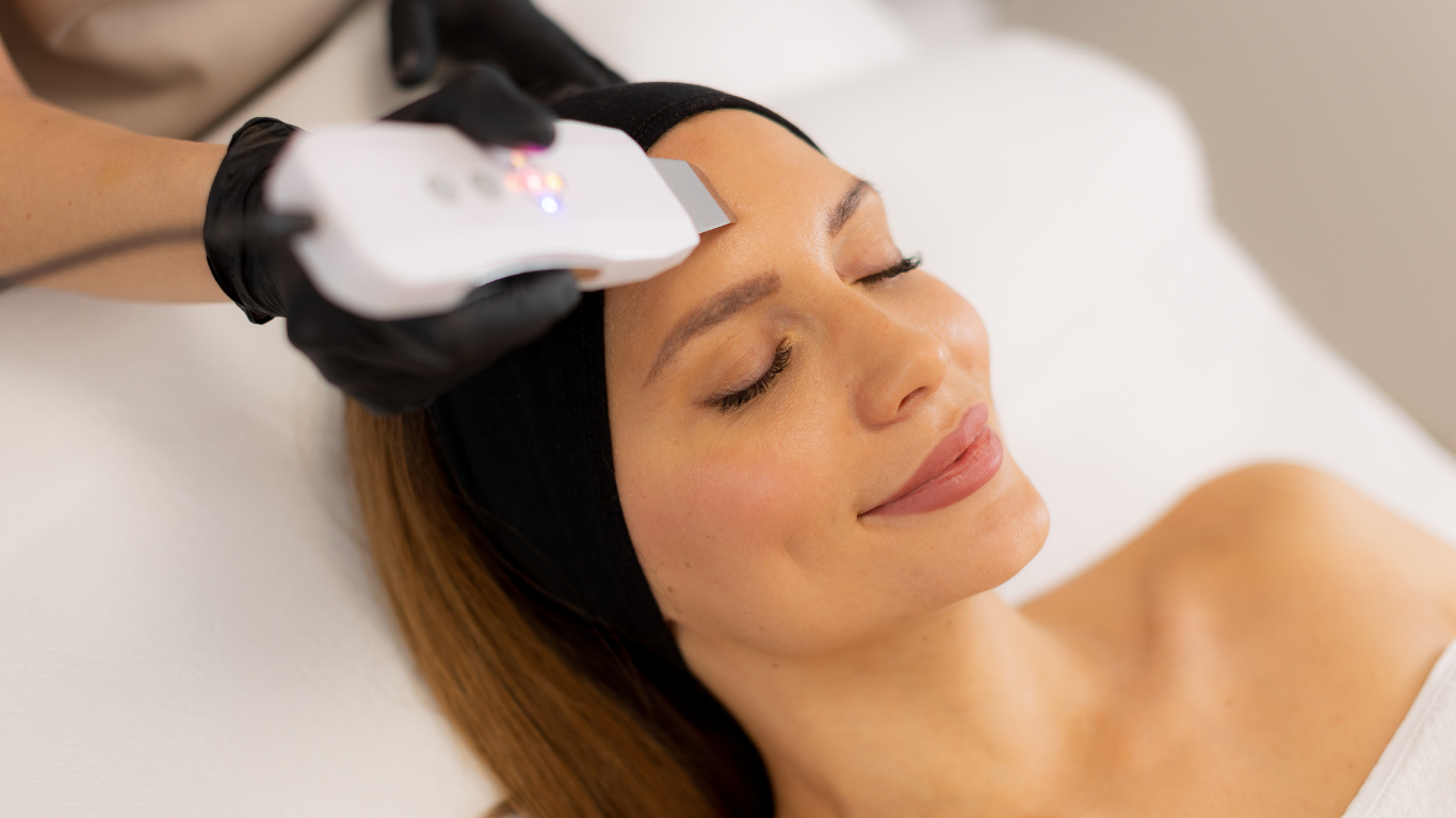 A woman is getting a facial treatment at a beauty salon.