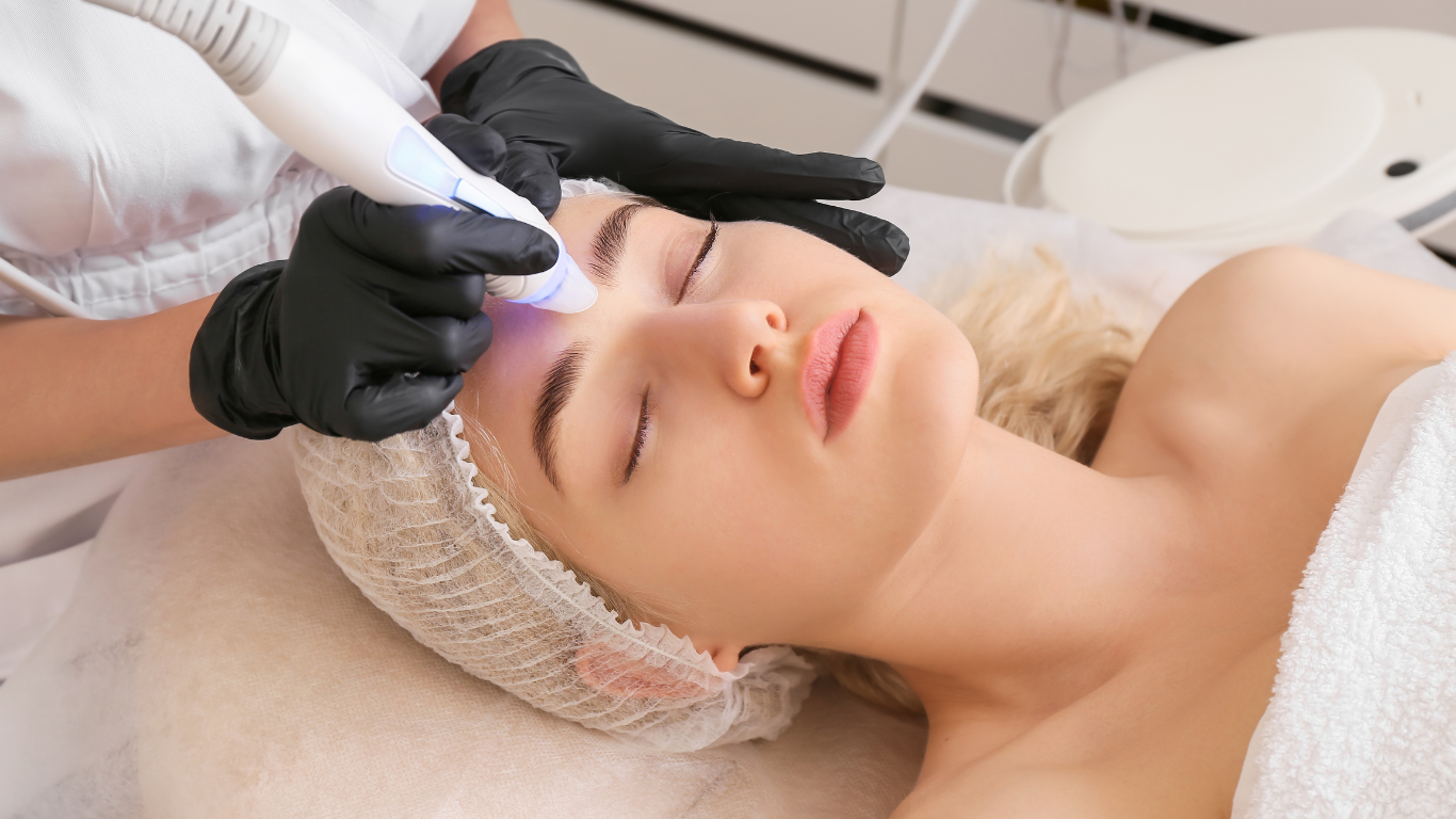 A woman is getting a facial treatment at a beauty salon.