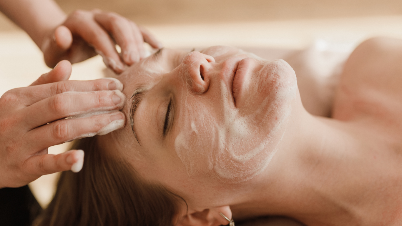 A woman is getting a facial treatment at a spa.
