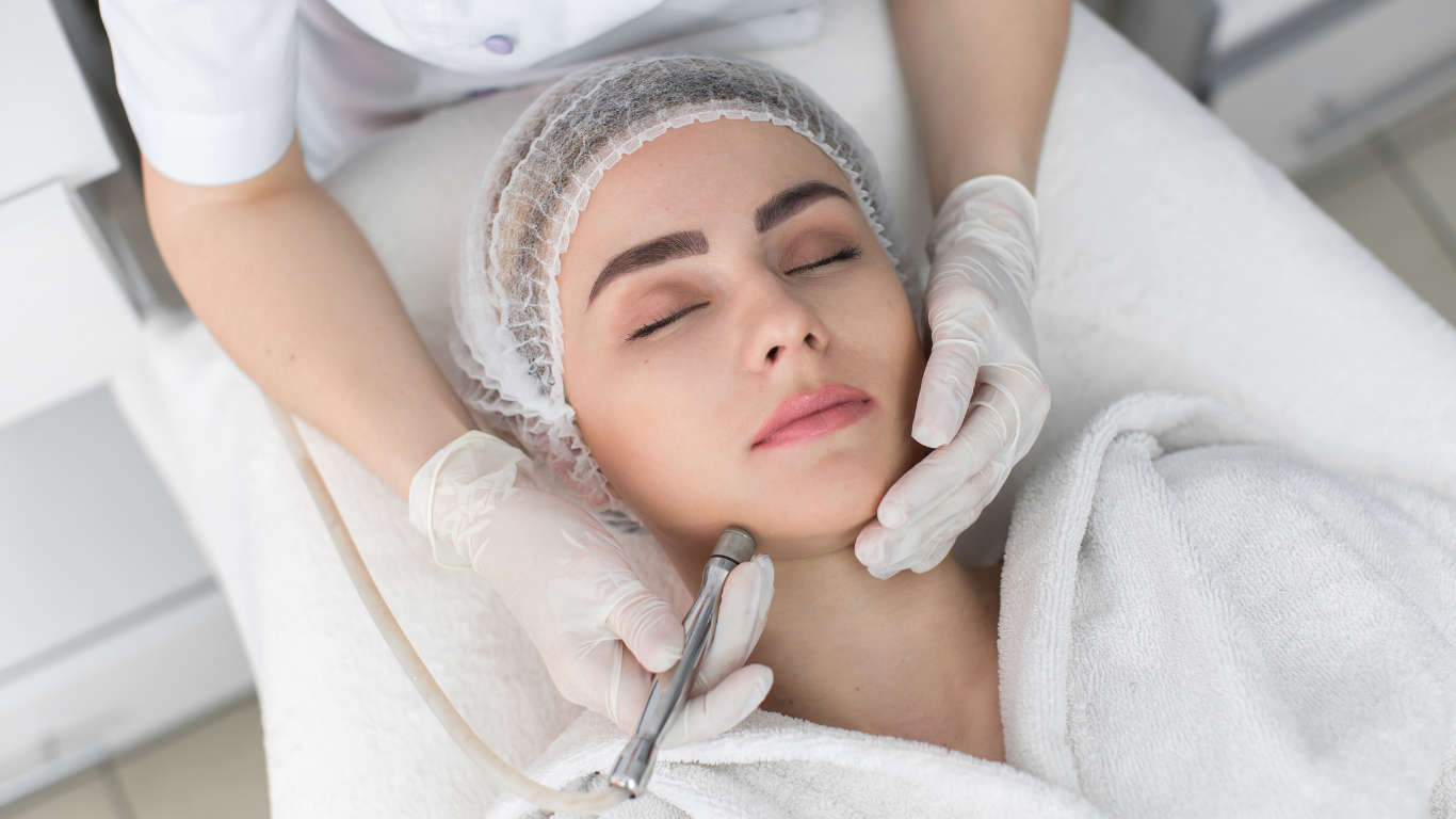 A woman is getting a facial treatment in a beauty salon.