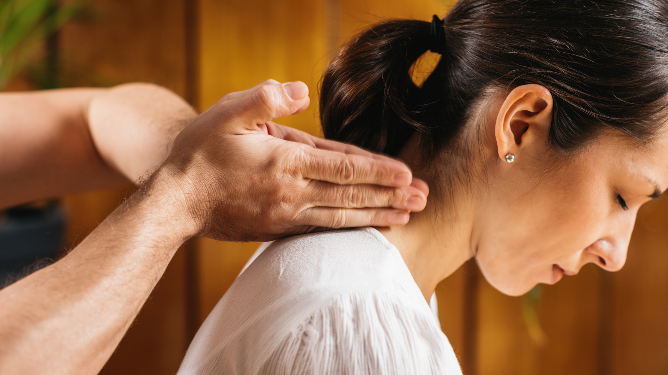 A woman is getting a massage from a man in a spa.