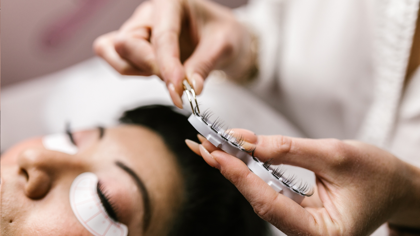 A woman is getting her eyelashes done at a beauty salon.