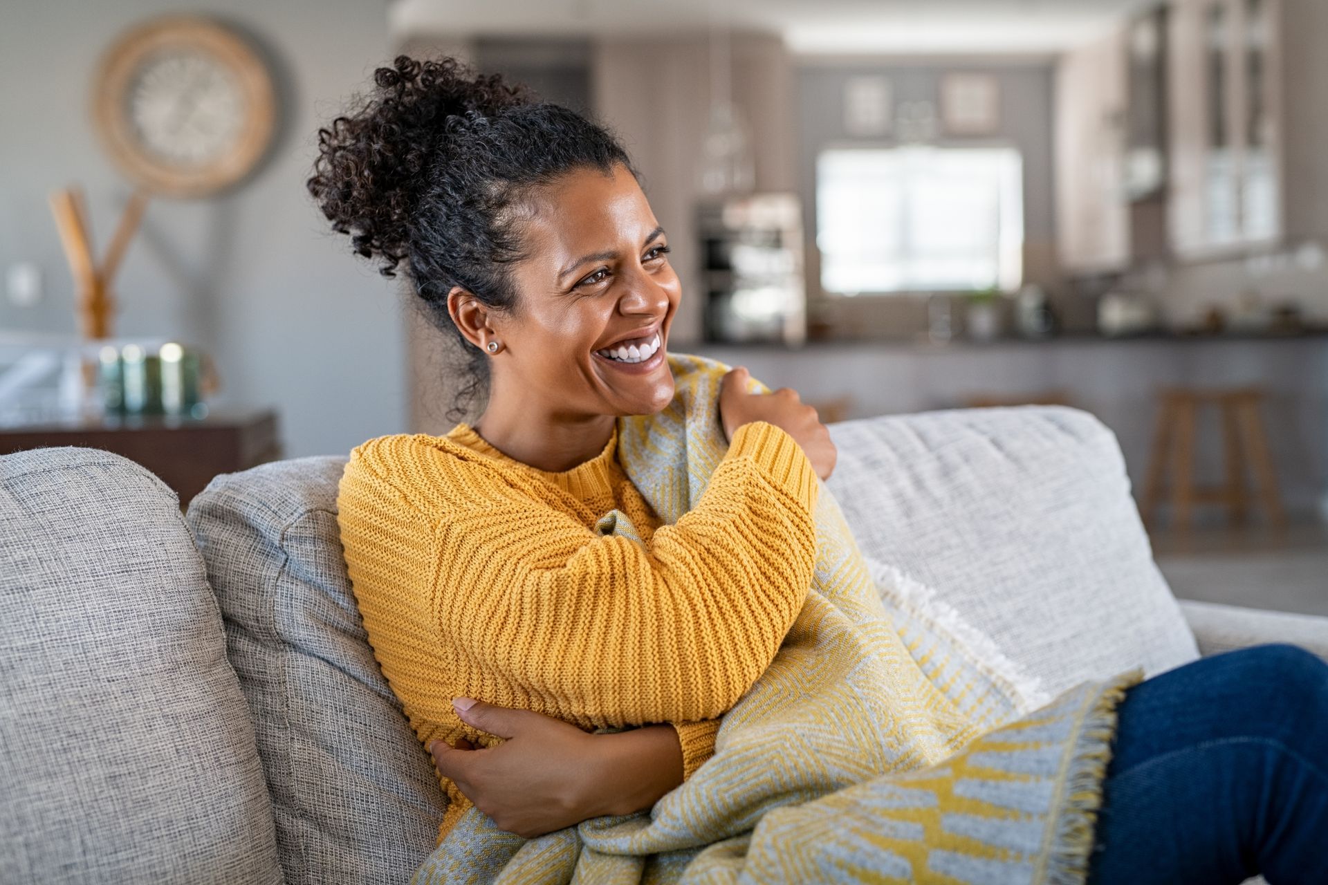 Middle-aged woman sitting on sofa