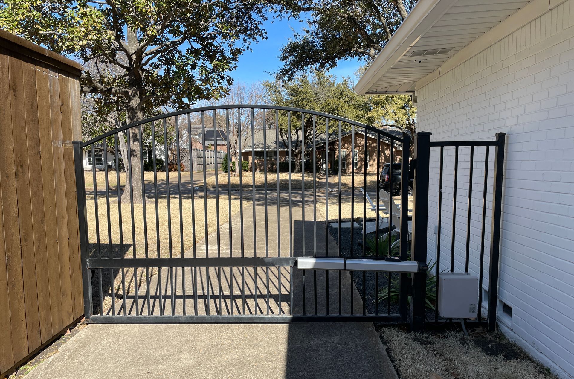 A white house with a black gate in front of it