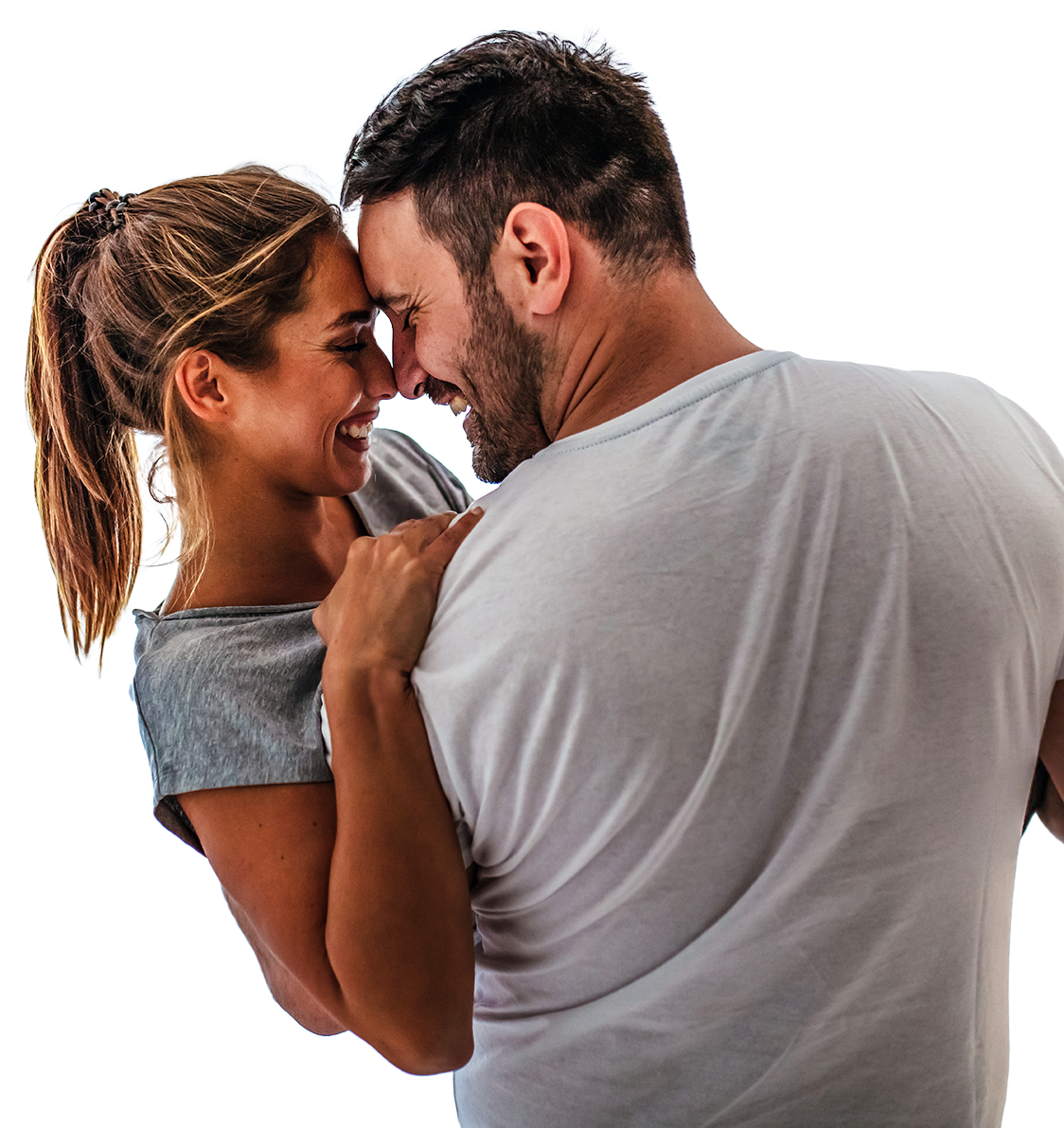 A man and woman are hugging and looking at each other