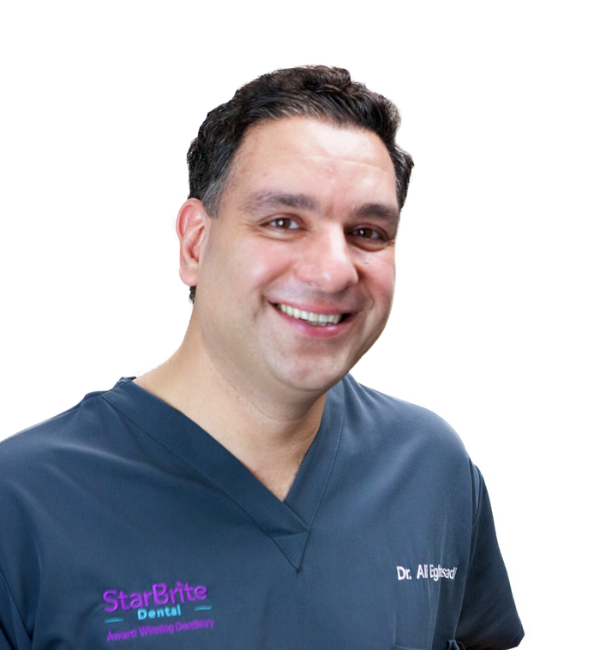 Smiling man in blue scrubs,