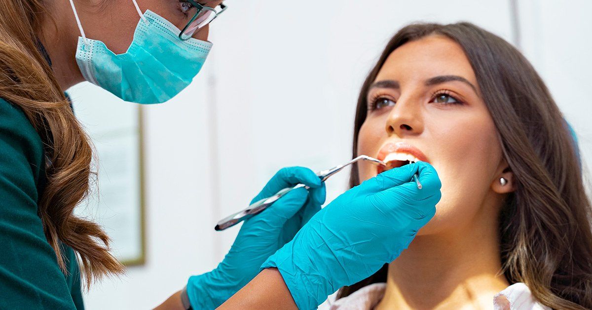 female patient being examined by female dentist for tooth erosion