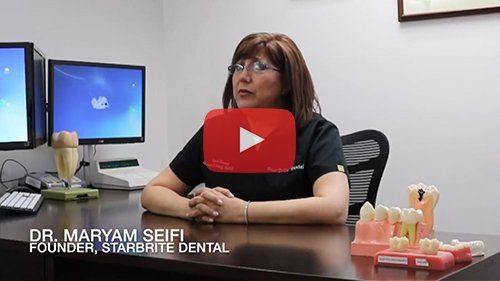 Dr. Maryam Seifi, female dentist in Rockville Maryland seated at desk
