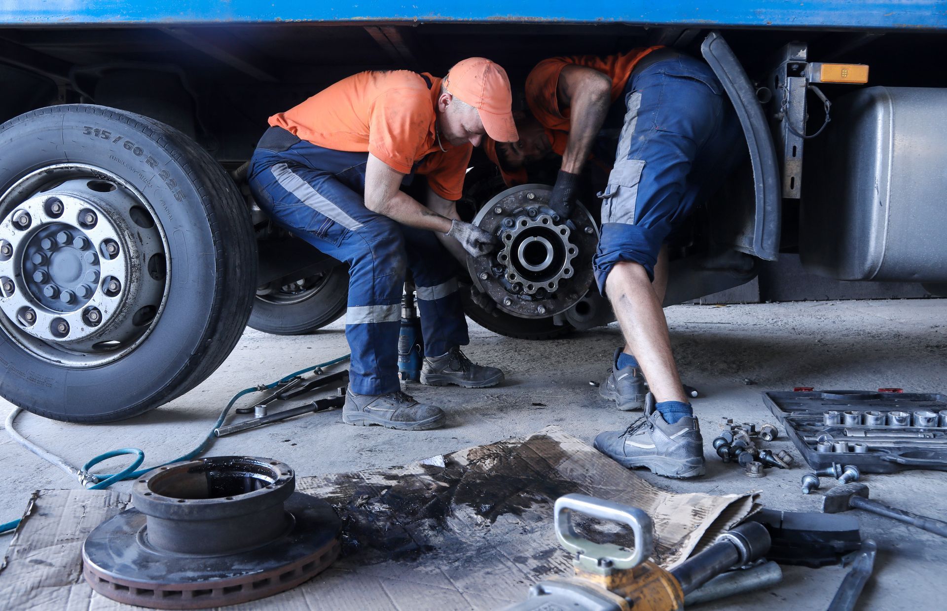 Two men are working on a trailer.