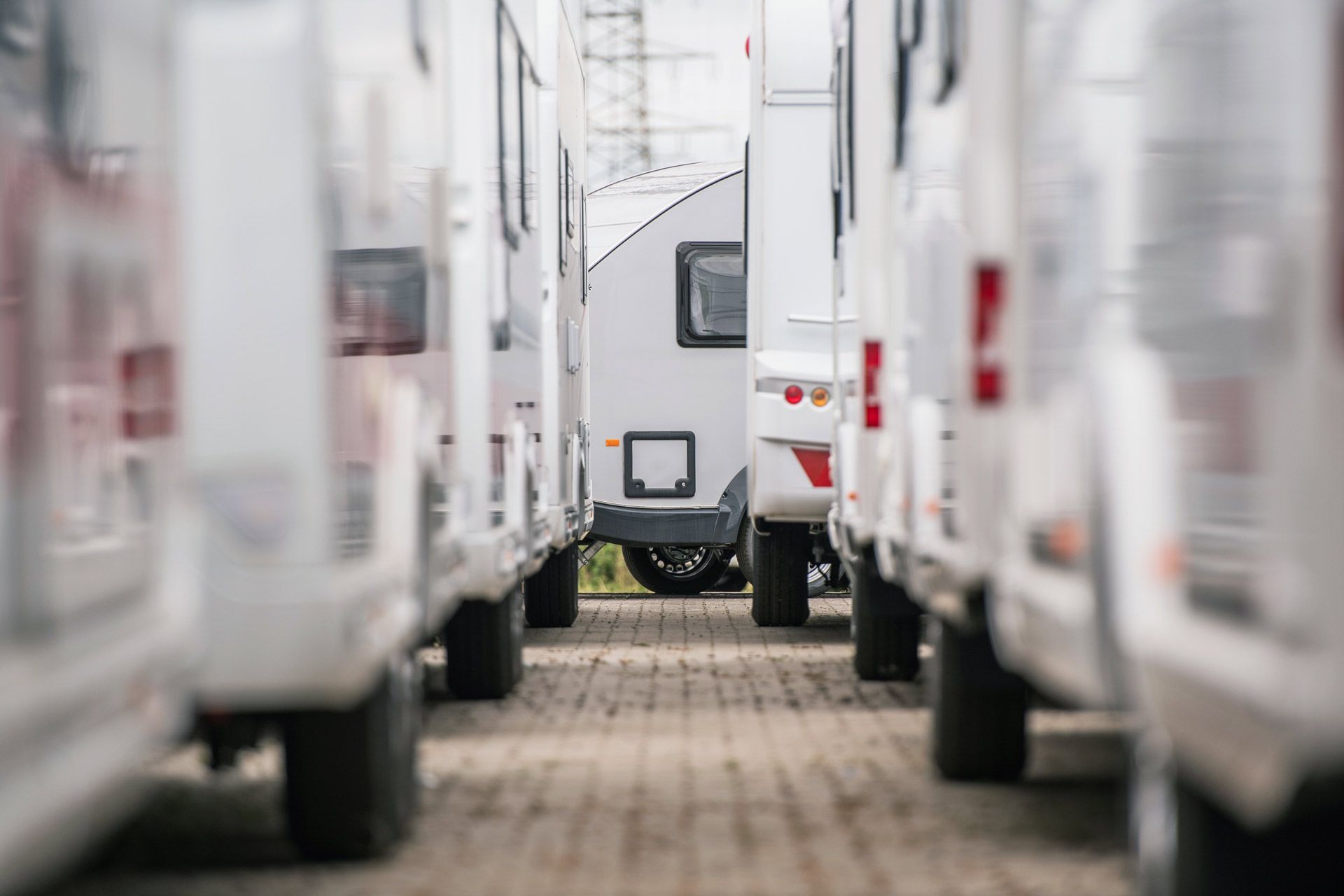 Trailer dealer showcasing white enclosed trailers lined up on dealership lot in Iowa.