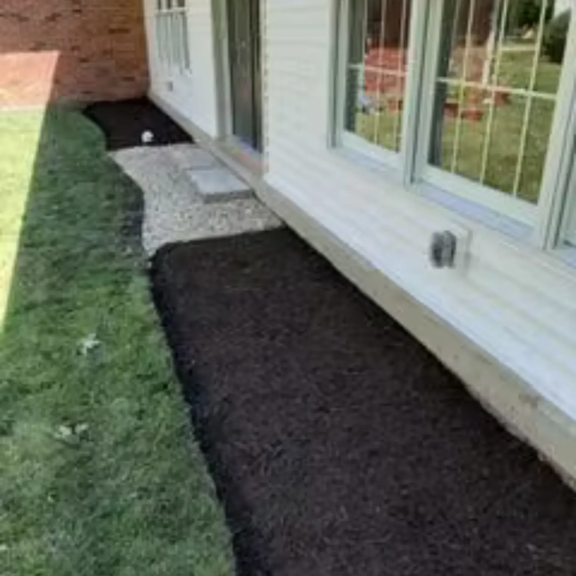 Green Wave Lawn Care - A gray house with a walkway leading to it