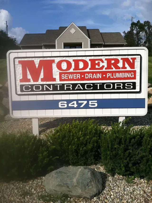 Sign for Modern Contractors with address 6475, sewer, drain, plumbing services.