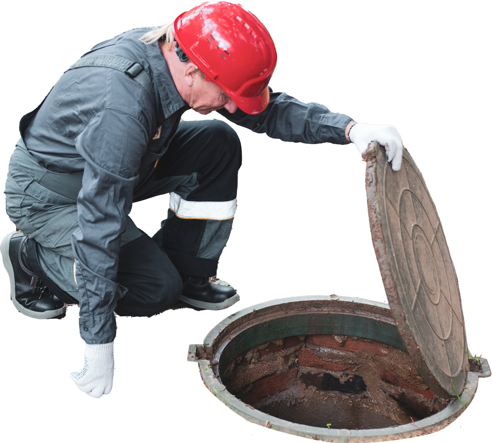 Person in uniform and hard hat inspecting an open manhole.