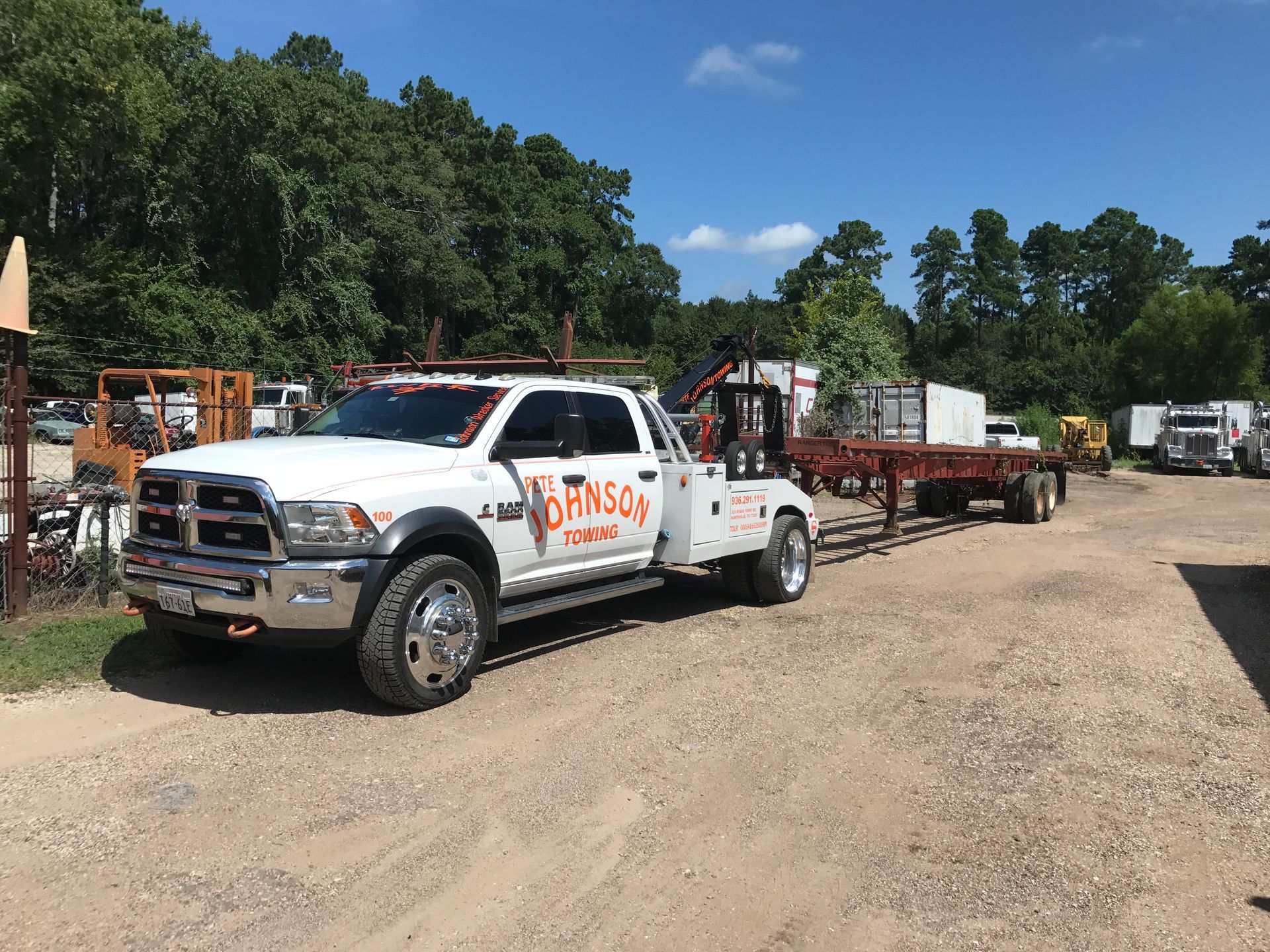 White tow truck with the name 