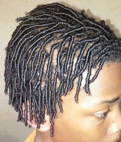 A close up of a person 's hair with dreadlocks