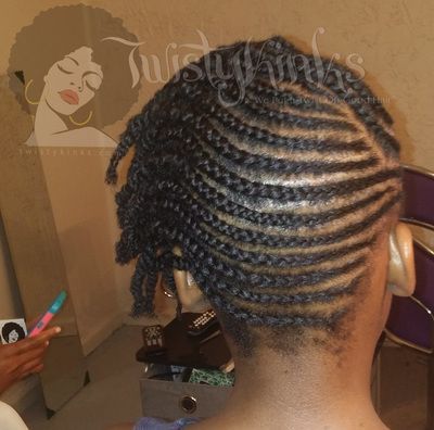 A woman with braided hair is sitting in front of a purple chair