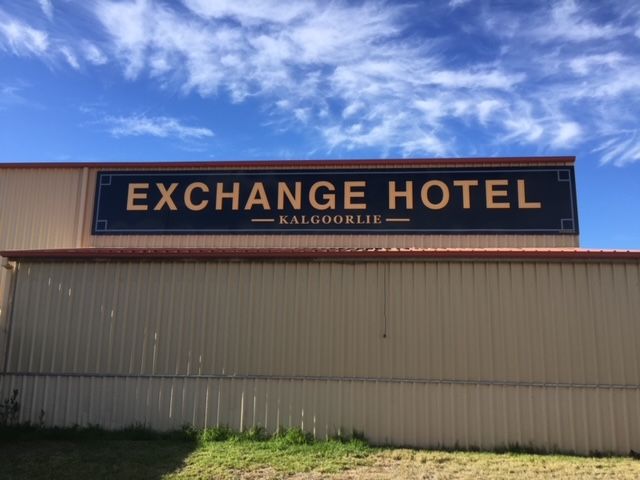 A sign on the side of a building that says exchange hotel
