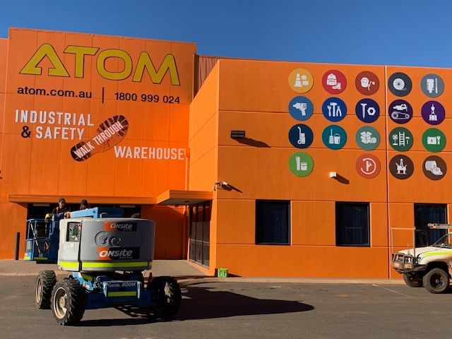 An orange building with the word atom on it
