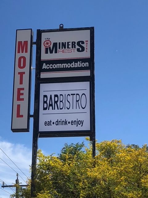 A sign for miners rest motel and barbistro