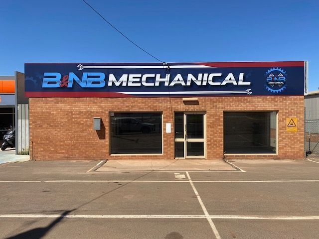 A brick building with a sign that says banb mechanical