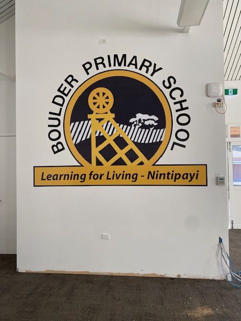 A boulder primary school logo on a white wall