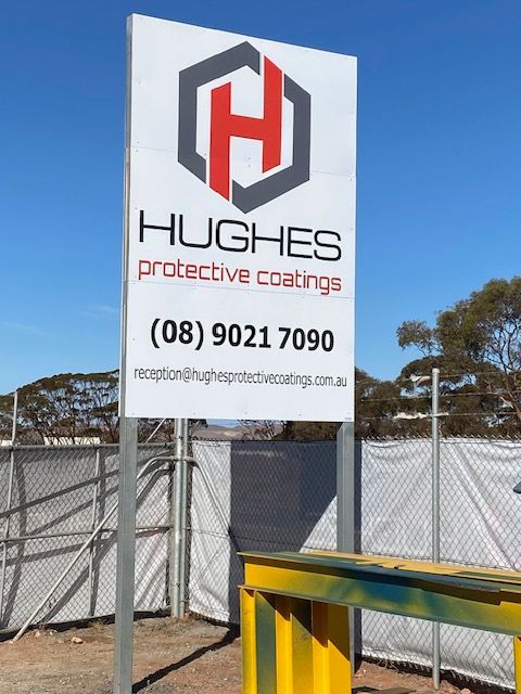 A sign that says hughes protective coatings on it