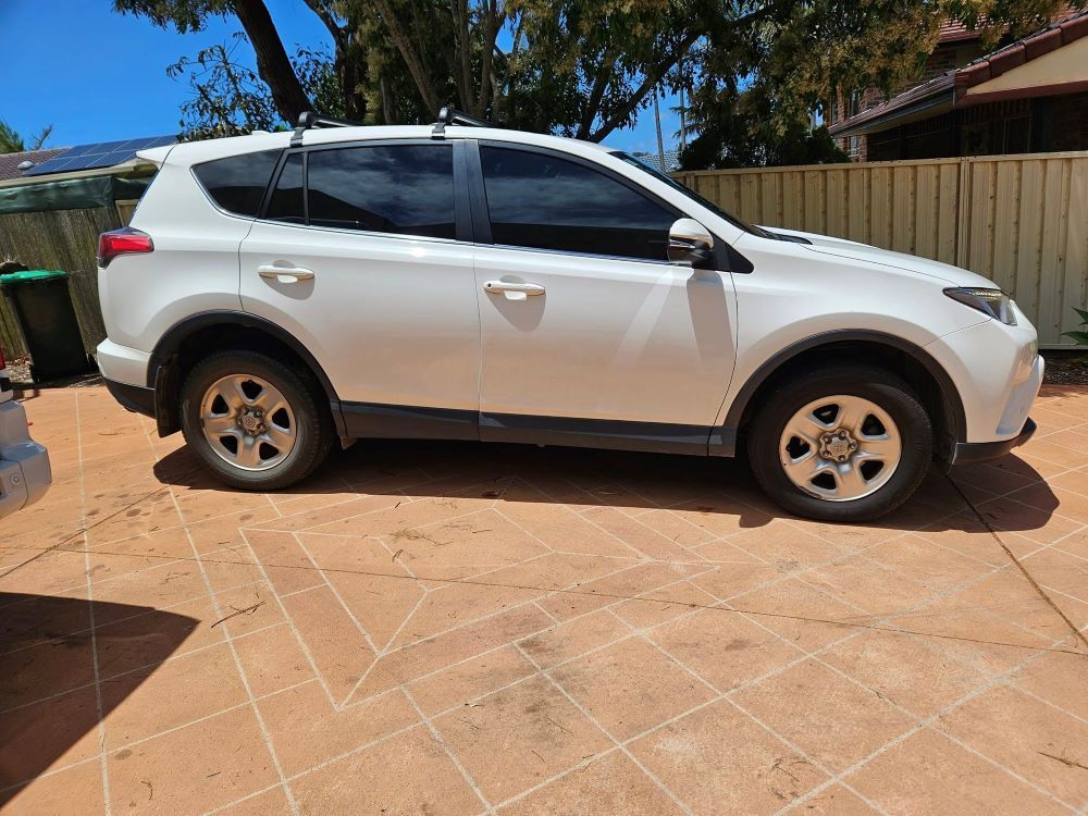 A White Suv is Parked With a Tinted Window — PJ Tinting In Port Macquarie, NSW